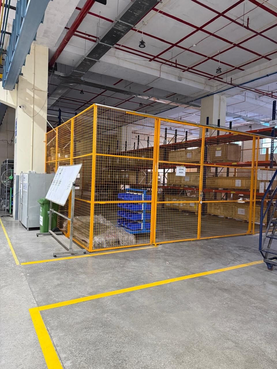 Wire-mesh store enclosure built by Sigma Tex on a factory floor